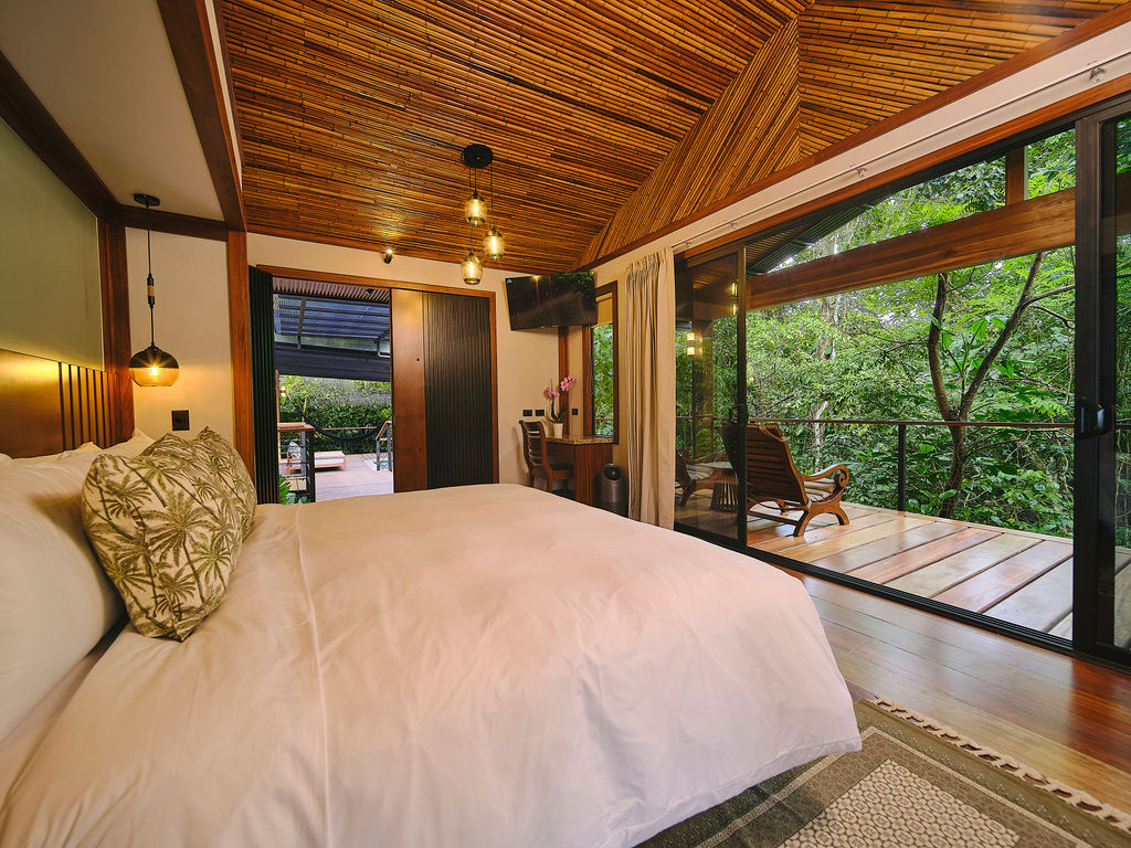 Bedroom with sliding doors open to the deck and a rocking chair