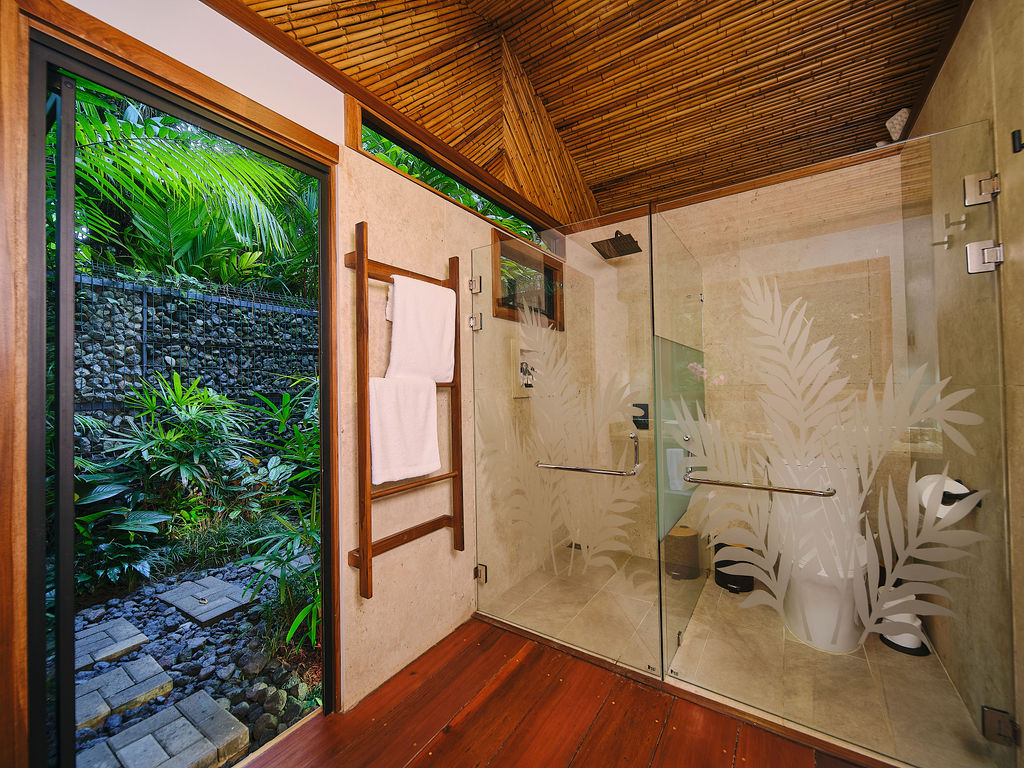 Glass-walled shower beside the garden door in the Bungalow Deluxe King