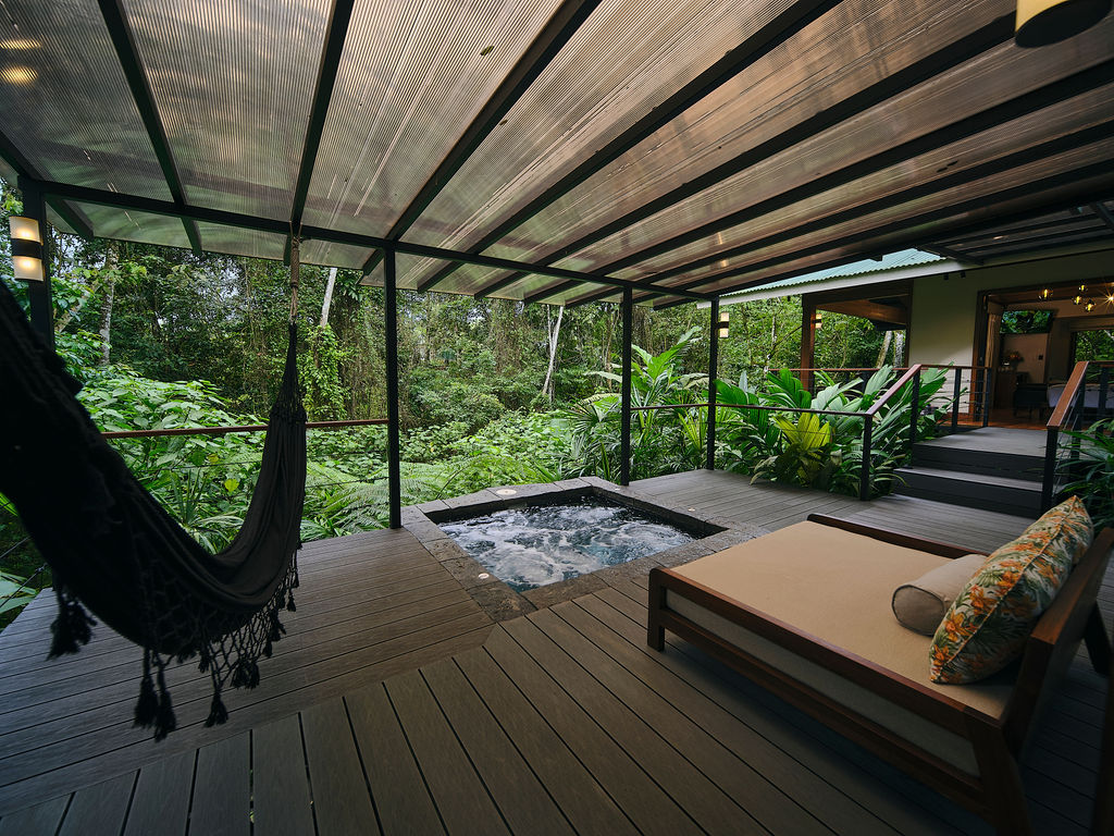 Private jacuzzi, hammock and daybed on a covered bungalow deck