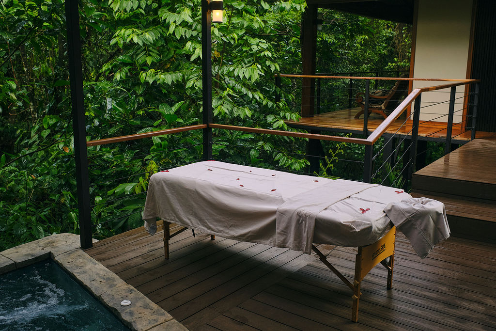 Massage table beside a bubbling private jacuzzi
