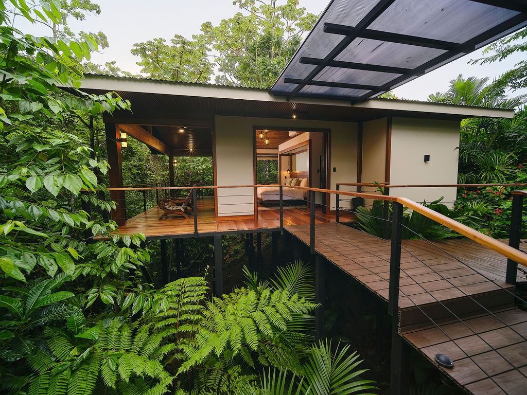 Wooden bridge leading through the forest to the Bungalow Luxury King