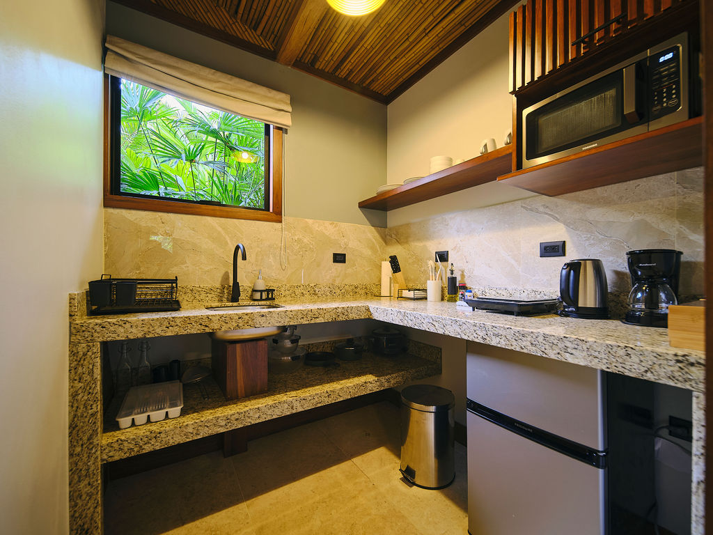 Kitchenette with granite counter, kettle and coffee maker