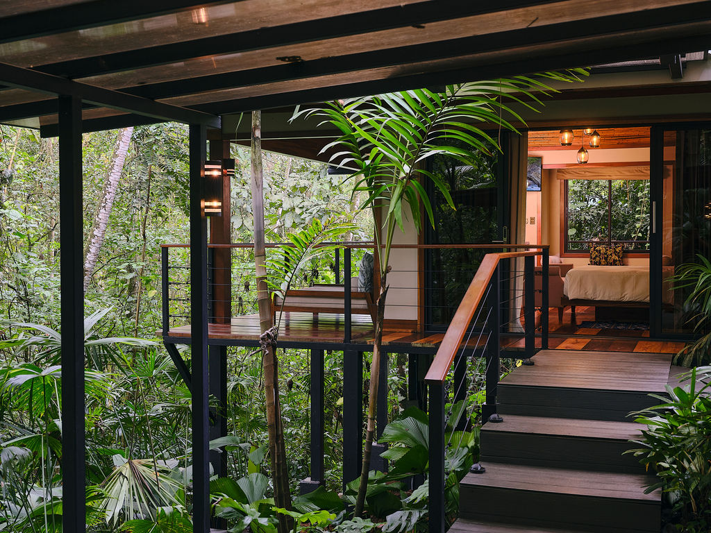 Covered walkway and steps leading to a bungalow entrance
