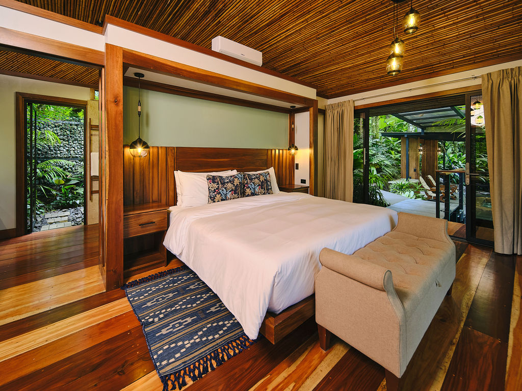 King bed of the Bungalow Deluxe King opening onto the deck