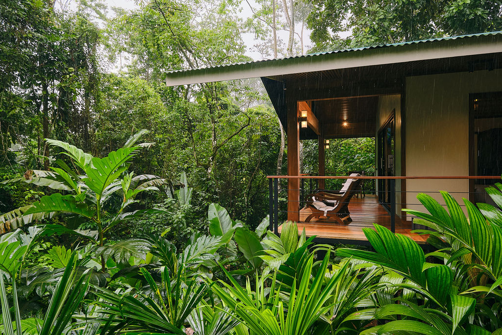 Bungalow porch lit at the edge of the rainforest at Secret Bungalows Lechu
