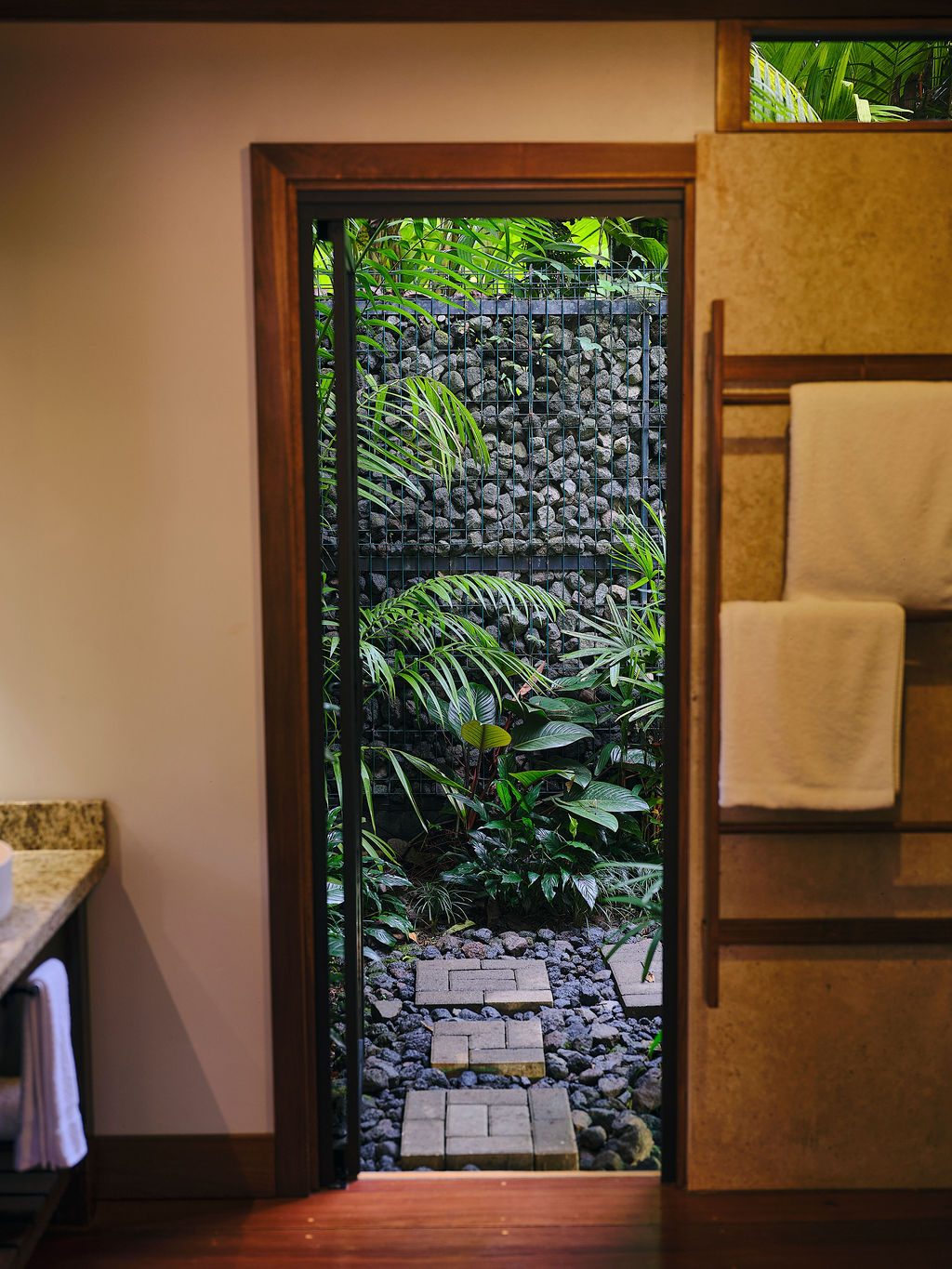 Doorway to the garden shower of the Bungalow Deluxe King