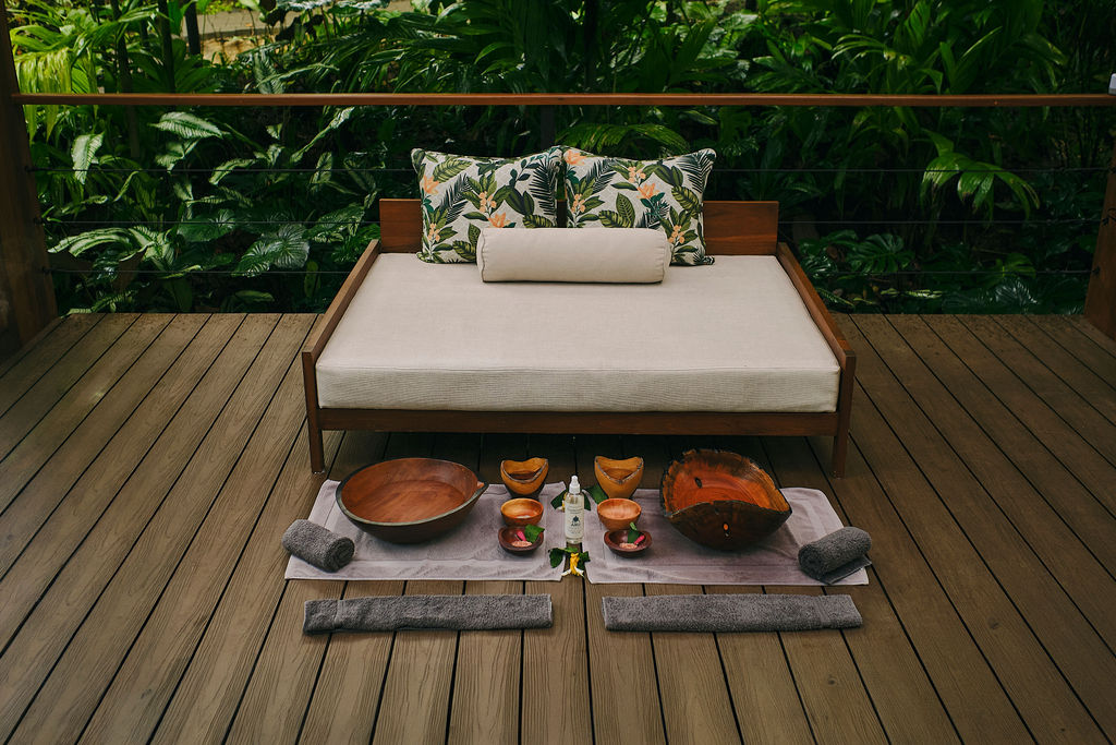 Spa daybed prepared with wooden bowls for a foot ritual