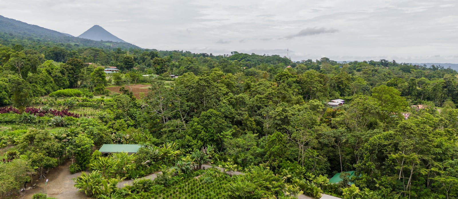Costa Rican countryside with the Arenal volcano rising in the distance