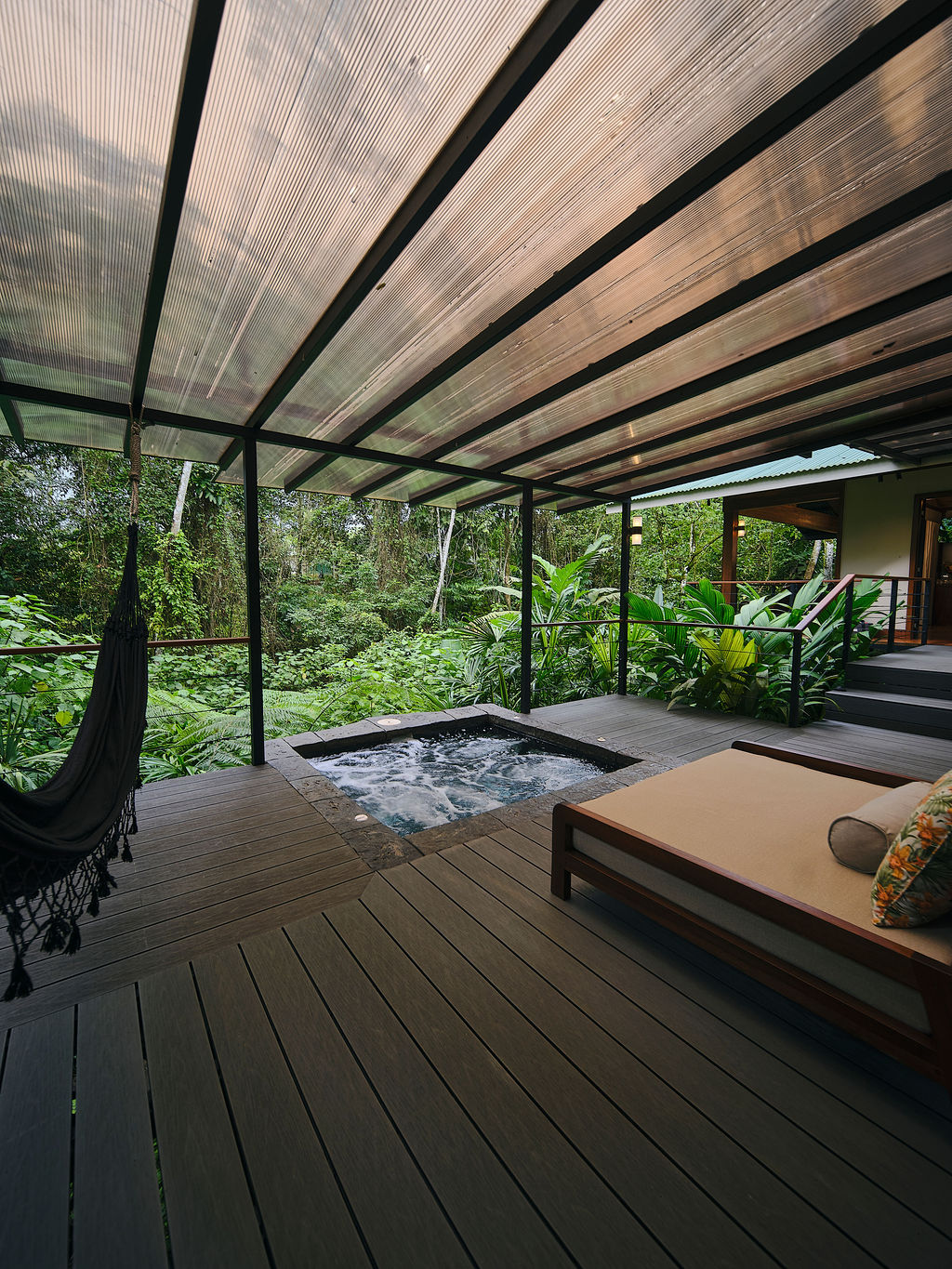 Hammock and private jacuzzi on the deck of the Bungalow Deluxe King Waterfall
